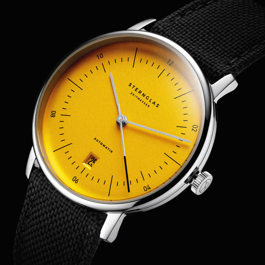 popup|Yellow, domed dial|Grey hands and a framed date together with the satin-finish dial round off the reduced overall appearance