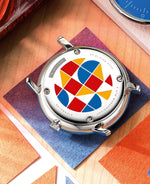 popup|Artful case back with palpable enamel engraving|The screwed case back of this special edition speaks for itself. Primary colors made of enamel, cast in an elaborate and precise form. In addition, the limited edition number makes each piece unique.